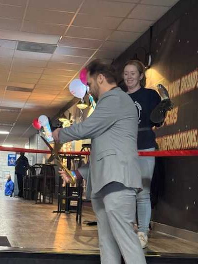 cutting ribbon at the grand opening of the Power-Up Lounge at Berglund Center!